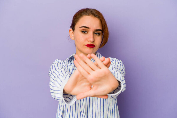 Young arab mixed race woman doing a denial gesture