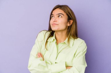 Mor arka planda genç, sıska beyaz kız hedeflere ve amaçlara ulaşma hayali kuruyor.