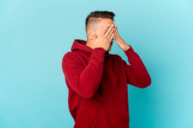 Genç, beyaz, yakışıklı bir adam izole edilmiş. Gözleri elleriyle kapatmaktan korkuyor..