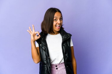 Genç melez kadın göz kırpıyor ve elleriyle iyi bir jest yapıyor..