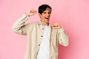 Genç, sıska İspanyol adam özel bir günü kutluyor, atlıyor ve enerjiyle kollarını kaldırıyor..