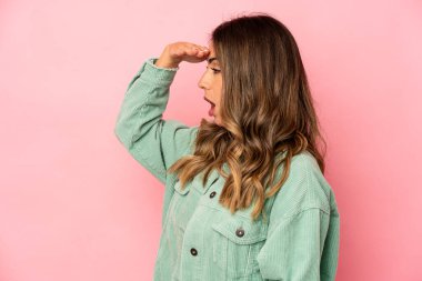 Kafkasyalı genç bir kadın çok uzaklara bakıyor ve elini alnında tutuyor..