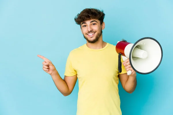 Young Arab Man Holding Megaphone Smiling Pointing Aside Showing Something — Foto Stock