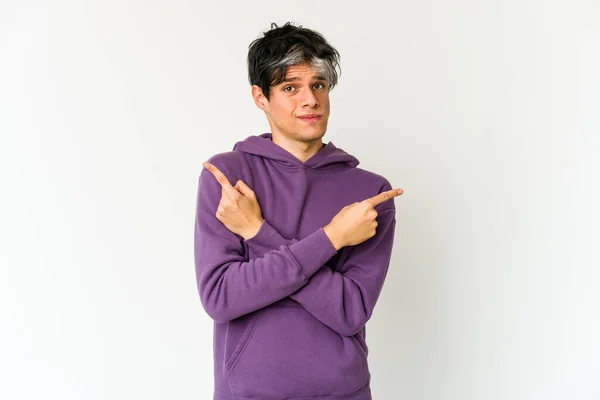 Young Skinny Hispanic Man Points Sideways Trying Choose Two Options — Stock Photo, Image