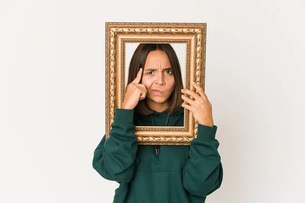 Young Hispanic Woman Holding Old Frame Pointing Temple Finger Thinking — Stock fotografie