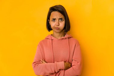 Sarı yanaklara izole edilmiş genç İspanyol kadın yorgun bir ifadeye sahip. Yüz ifadesi kavramı.