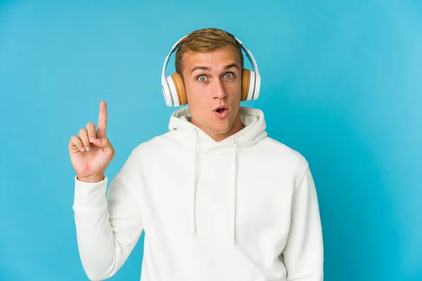 Giovane Uomo Caucasico Ascoltare Musica Isolata Sfondo Blu Avendo Qualche — Foto Stock