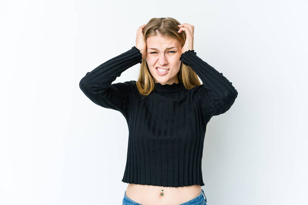 Young blonde woman isolated on white background screaming with rage.