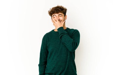 Beyaz arka plandaki genç Arap gülen, kaygısız, doğal duygular.