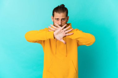 Uzun saçlı genç adam inkar hareketi yapıyor.