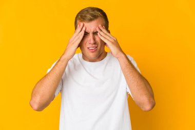 Genç beyaz yakışıklı adam tapınaklara dokunuyor ve baş ağrısı çekiyor..