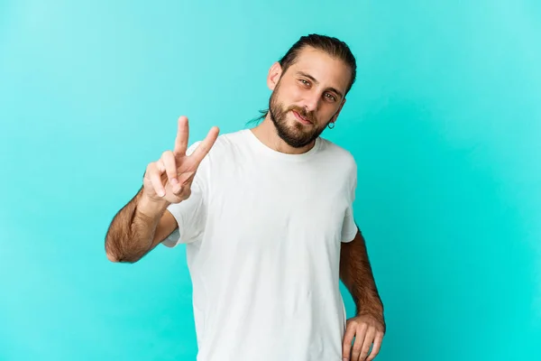 Young man with long hair look showing victory sign and smiling broadly.