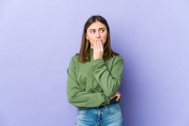 Genç beyaz kadın esniyor. Ağzı eliyle kapatan yorgun bir hareket sergiliyor..