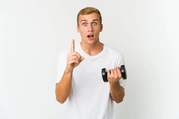 stock image Young caucasian man holding a weight isolated on white background having an idea, inspiration concept.
