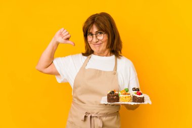 Middle age caucasian cook woman feels proud and self confident, example to follow.
