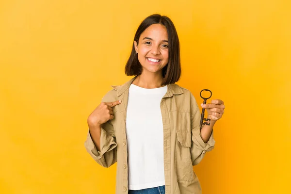 Young Hispanic Woman Holding Old Key Person Pointing Hand Shirt — Stok fotoğraf