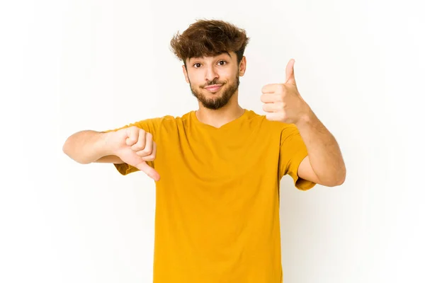 Young Arab Man White Background Showing Thumbs Thumbs Difficult Choose — Stock Photo, Image
