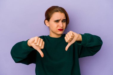 Genç Arap melez kadın baş parmağını aşağı gösteriyor, hayal kırıklığı konsepti..