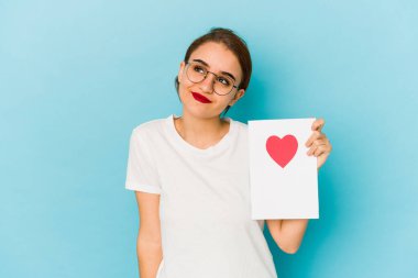 Genç, sıska bir Arap kız elinde sevgililer günü kartı ile amaçlarına ve amaçlarına ulaşmayı düşlüyor.