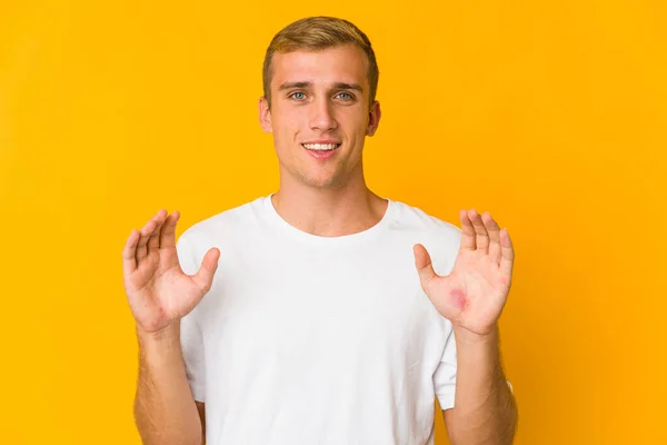 Young Caucasian Handsome Man Holding Something Little Forefingers Smiling Confident — Stock Photo, Image
