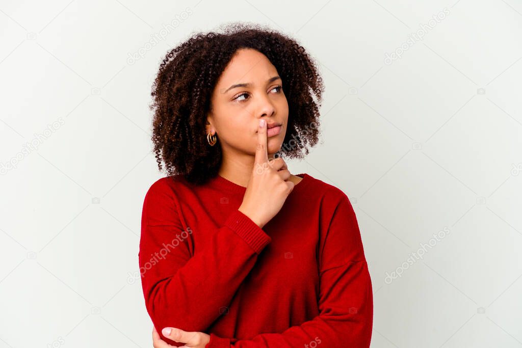 Young african american mixed race woman isolated looking sideways with doubtful and skeptical expression.