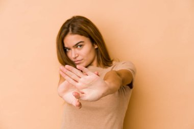 Genç, sıska, beyaz, genç bir kız elini uzatmış, dur işareti göstererek seni engelliyor..