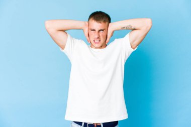 Genç, beyaz, yakışıklı, kulakları kulaklarıyla tıkayan, yüksek sesli sesler duymamaya çalışan adam..