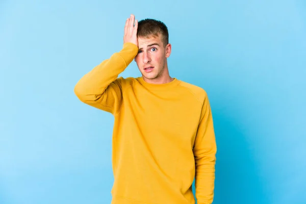 Young caucasian handsome man forgetting something, slapping forehead with palm and closing eyes.