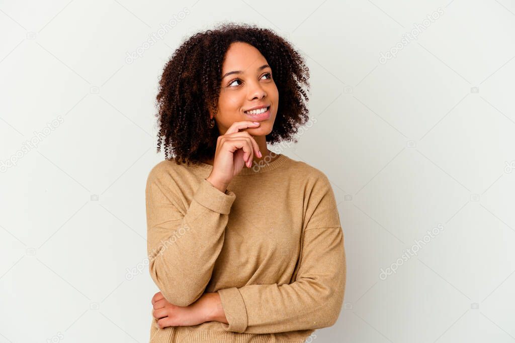 Young african american mixed race woman isolated relaxed thinking about something looking at a copy space.