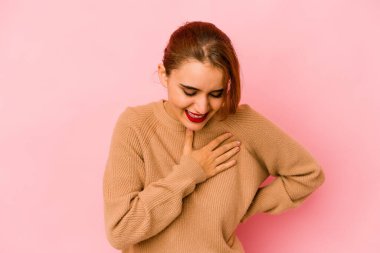 Genç Arap melez kadın gülüyor. Elini yüreğine koyuyor. Mutluluk kavramı..