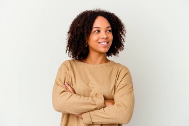 Genç Afro-Amerikan melez kadın kendini soyutlamış, kollarını kavuşturarak gülümsüyor..