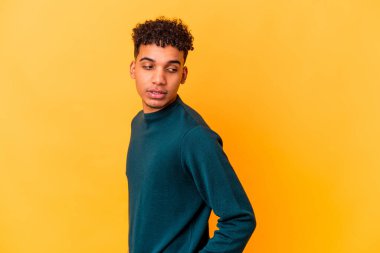 Genç Afro-Amerikan kıvırcık adamı, mor bakışları bir kenara bırakırsak gülümseyen, neşeli ve keyifli..