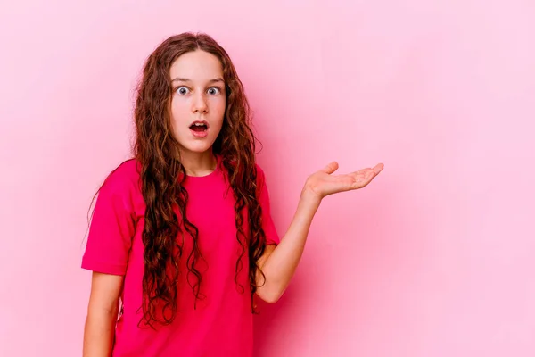 Little Caucasian Girl Isolated Pink Background Impressed Holding Copy Space — Stock Photo, Image