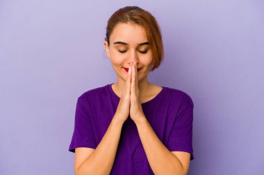 Genç Arap melez kadın el ele tutuşuyor. Ağız kenarında dua ediyor. Kendine güveniyor..