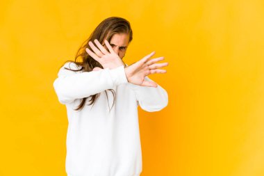 Uzun saçlı genç adam iki kolu çapraz tutuyor, inkar kavramı..