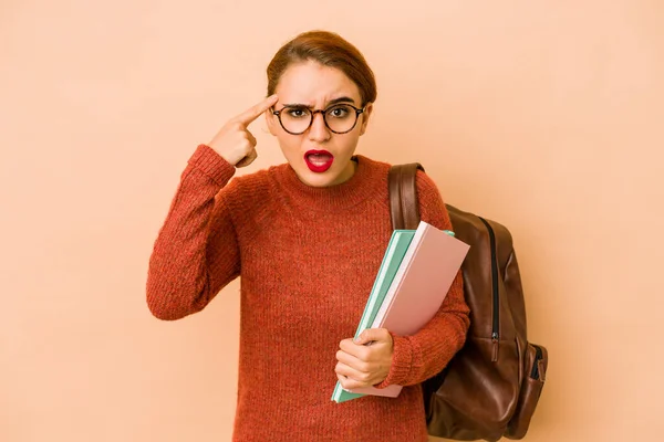 Young skinny arab student woman showing a disappointment gesture with forefinger.