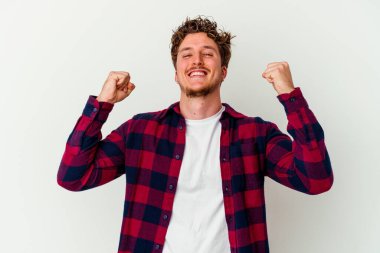 Beyaz arka planda izole edilmiş genç beyaz adam tasasız ve heyecanlı bir şekilde tezahürat yapıyor. Zafer konsepti.