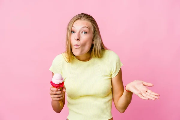 Young Russian Woman Eating Ice Cream Isolated Shrugs Shoulders Open — Stock Photo, Image