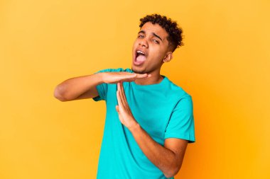 Genç Afro-Amerikalı kıvırcık adam, mor üzerine izole edilmiş bir şekilde mola veriyor..