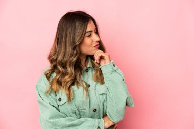 Kafkasyalı genç bir kadın şüpheli ve şüpheci bir ifadeyle yanlamasına bakıyor..