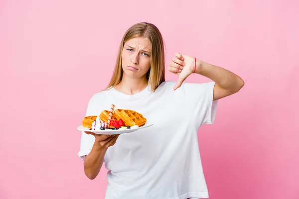 Young Russian Woman Eating Waffle Isolated Showing Thumb Expressing Dislike — Stock Photo, Image