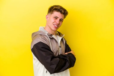 Sarı arka planda izole edilmiş genç beyaz adam mutlu, güler yüzlü ve neşeli..