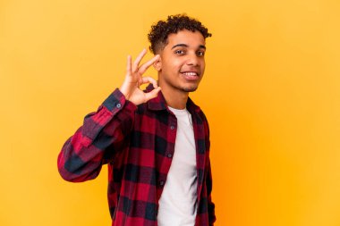 Genç Afro-Amerikalı kıvırcık adam mor renkli, neşeli ve kendinden emin bir şekilde izole edilmiş..