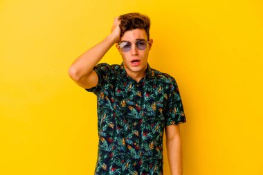Sarı arka planda izole edilmiş Hawaii tişörtü giyen genç beyaz adam yorgun ve uykulu..