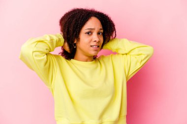 Genç Afro-Amerikan melez kadın kafasının arkasına dokunuyor, düşünüyor ve bir seçim yapıyor..