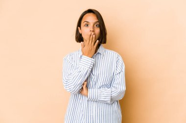 Genç İspanyol kadın şok olmuş, ağzı ellerle kaplanmış, yeni bir şey keşfetmek için sabırsızlanıyor..