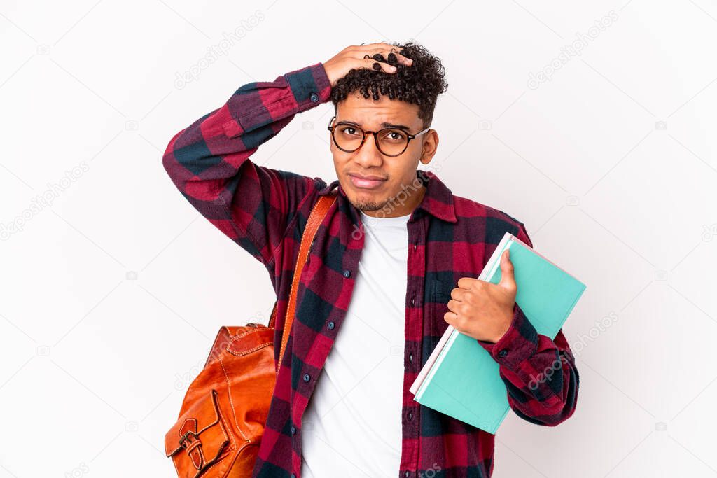 Young african american student curly man isolated holding books being shocked, she has remembered important meeting.