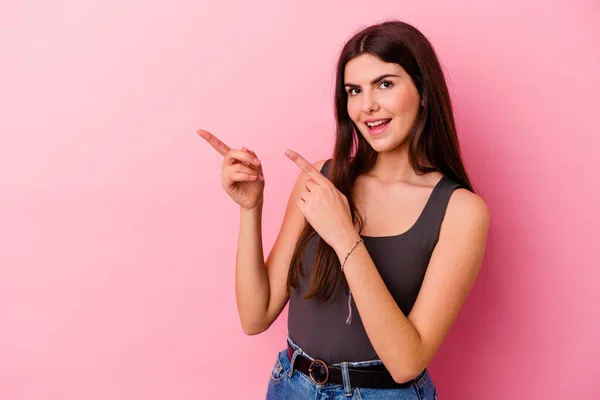 Young Caucasian Woman Isolated Pink Background Excited Pointing Forefingers Away — Stock Photo, Image