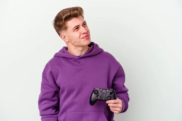 Jovem Caucasiano Segurando Gamepad Isolado Fundo Branco Sonhando Alcançar Objetivos — Fotografia de Stock