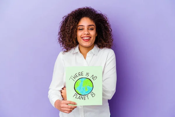 Young African American woman holding a There is no planet B placard isolated laughing and having fun.
